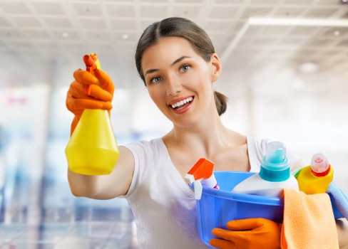 Operator handling cleaning chemicals with gloves